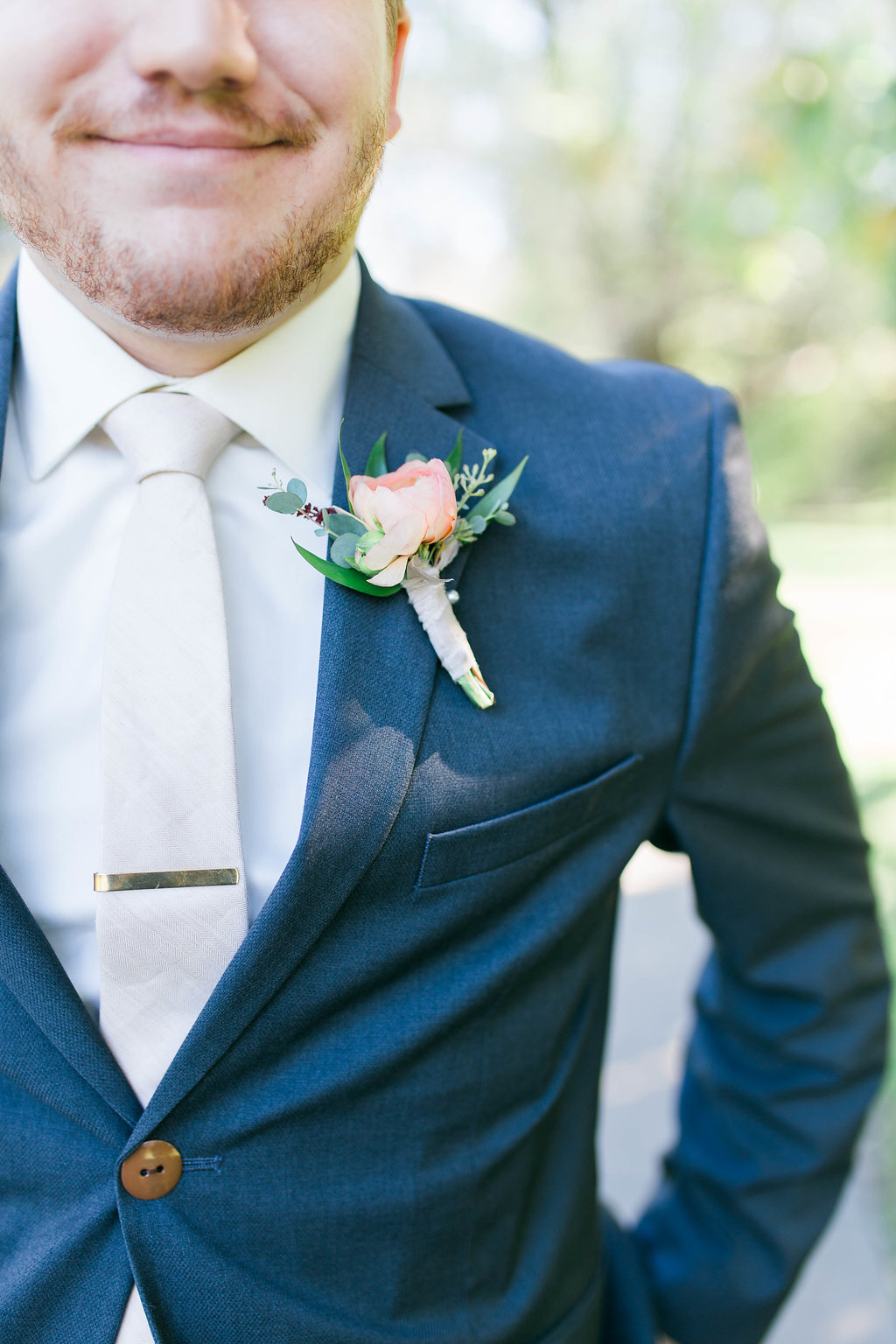 a picture of a groom's navy blue suit